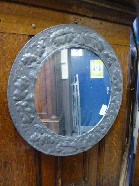 An arts and crafts style circular mirror