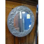 An arts and crafts style circular mirror