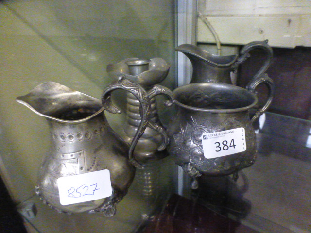 Two pewter cream jugs together with a pe