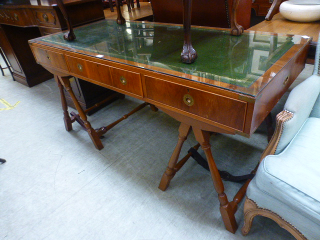 A reproduction yew campaign style desk