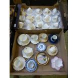 Two trays of decorative cups and saucers