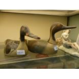 Two wooden decoy ducks