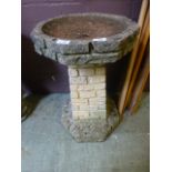 A composite stone bird bath