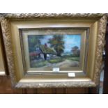 A framed and glazed oil of country lane