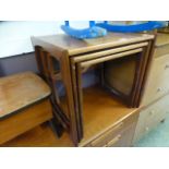 A nest of three teak occasional tables