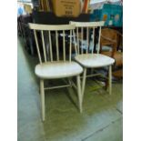 Two white stick back chairs