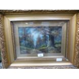 An ornate gilt framed oil of woodland la