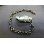 A whistle in the form of a dog on chain