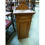 An early 20th century oak box with lift