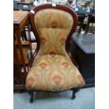 A reproduction spoon back nursing chair