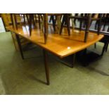 A mid-20th century teak extending dining