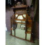 An Edwardian carved walnut over mantle m