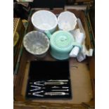 A tray containing ceramic jelly moulds,