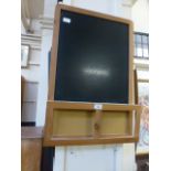A wall mounted blackboard with hooks