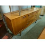 A mid-20th century teak sideboard with t