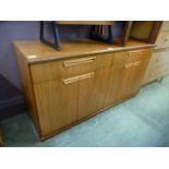 A mid 20th century teak sideboard having