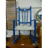 A blue painted child's rocking chair