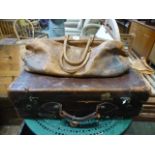 A leather suitcase together with a tan l