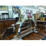 A rocking horse on swing base in dappled