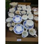 A tray of blue and white mugs, water jug