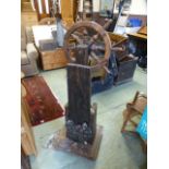 A pine ships wheel on stand