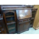 An early 20th century oak cabinet, havin