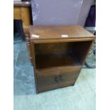 A small wooden cabinet with open storage