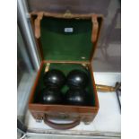 A set of four wooden bowls in travelling
