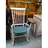 A white painted stick back rocking chair