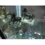 Two cast models of horses, one on a marb