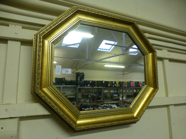 An ornate gilt framed octagonal mirror