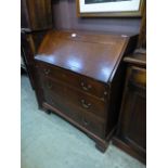 An 18th century oak bureau, the fall fro