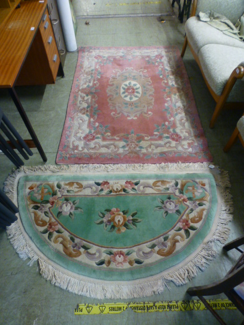 A rectangular pink Chinese rug together