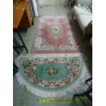 A rectangular pink Chinese rug together