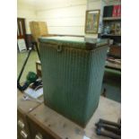 A green painted Lloyd Loom laundry baske