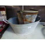 A galvanized metal bucket together with