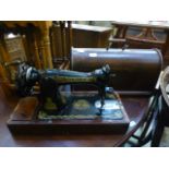 A cased manual Singer sewing machine