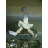 A Nao figure of a seated ballerina