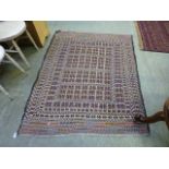 A hand woven Turkish rug with geometric