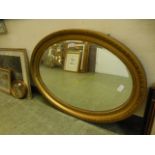 A gilt framed oval bevel glass mirror