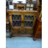 A reproduction oak bookcase, the leaded