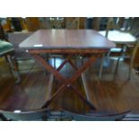 A mahogany effect folding table