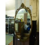 A gilt metal framed oval mirror