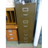 A metal four drawer filing cabinet with