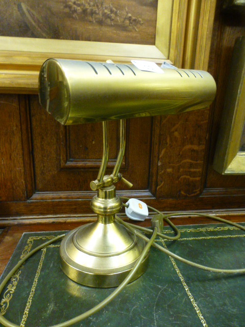 A reproduction brass adjustable desk lam
