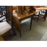 A mid-20th century teak drop-leaf dining