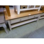A grey painted low coffee table with fou