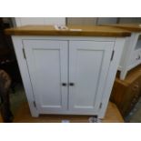 An ivory painted two door cupboard (82.2
