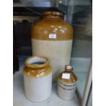 A large stoneware storage jar together w