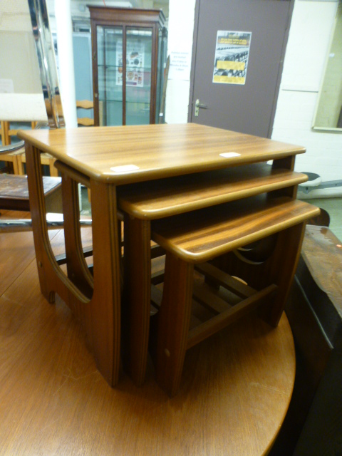 A nest of three teak veneered occasional